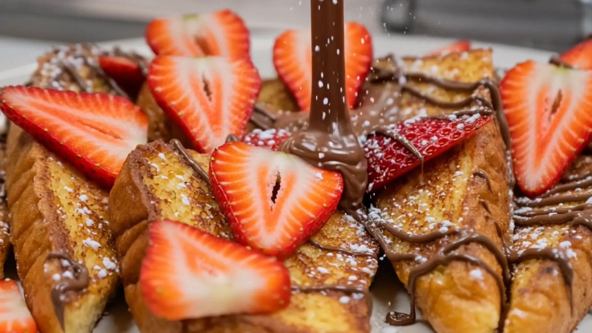 Strawberry French toast with chocolate being poured over it
