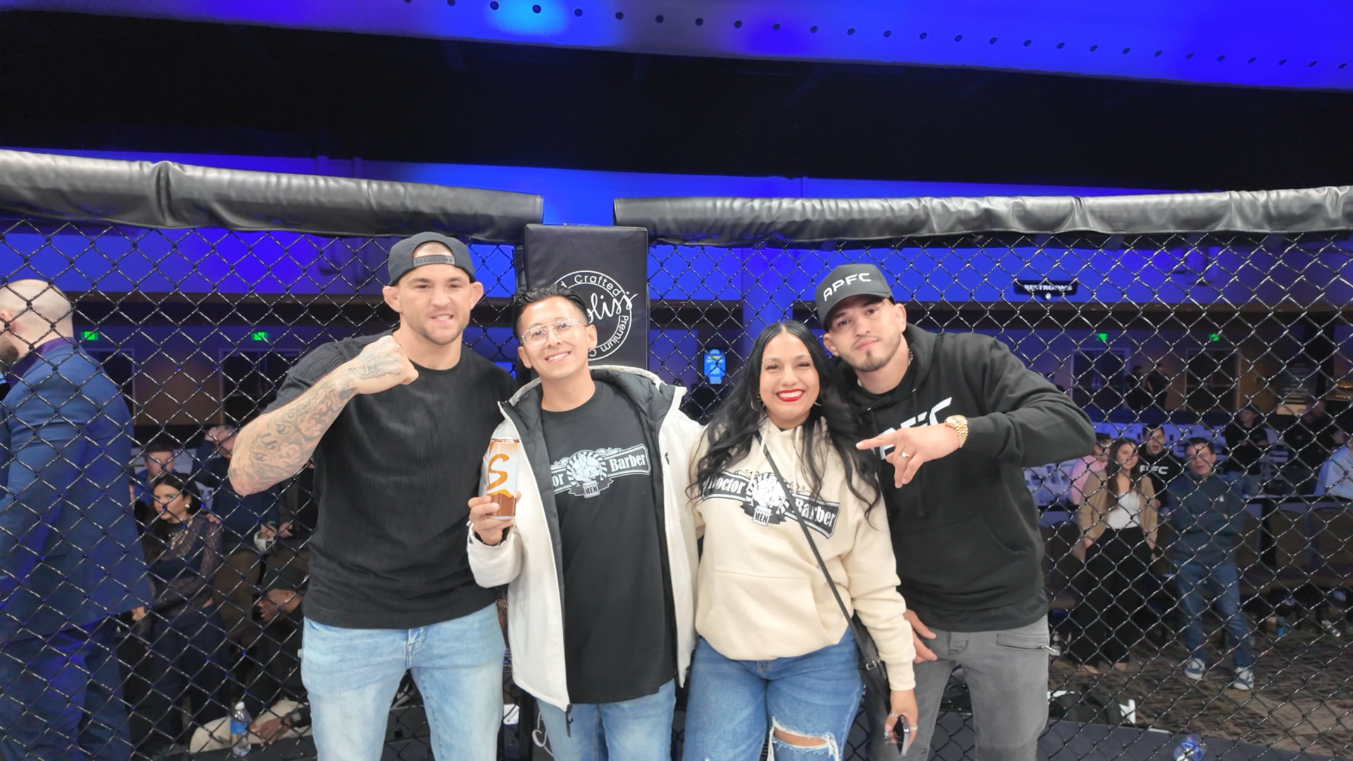 Group photo cageside at an APFC event, including Dustin Poirier and Anthony Pettis