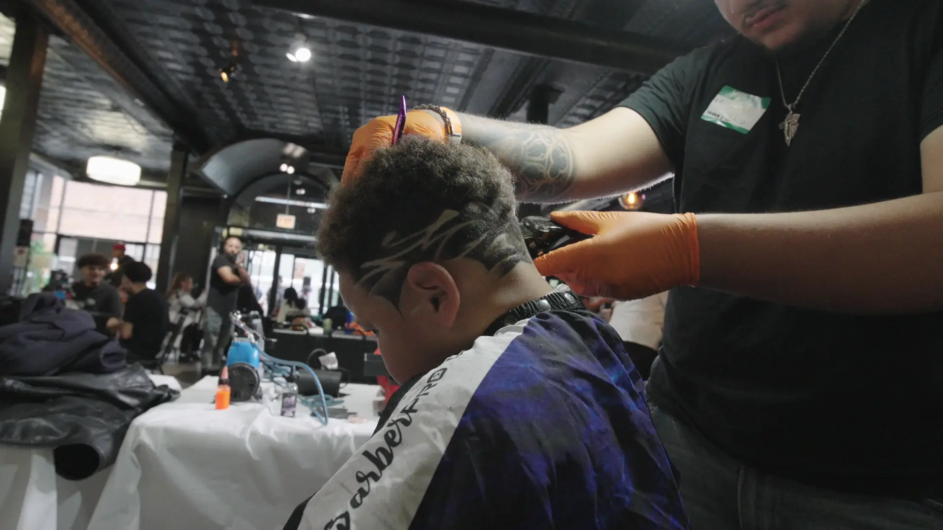 Barber creating a detailed haircut with clippers