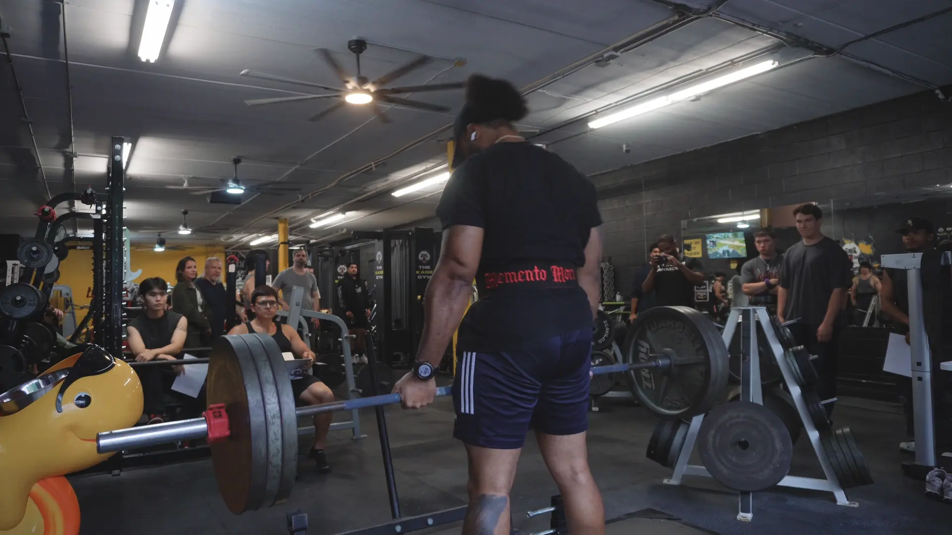 Athlete lifting a loaded barbell at a gym event